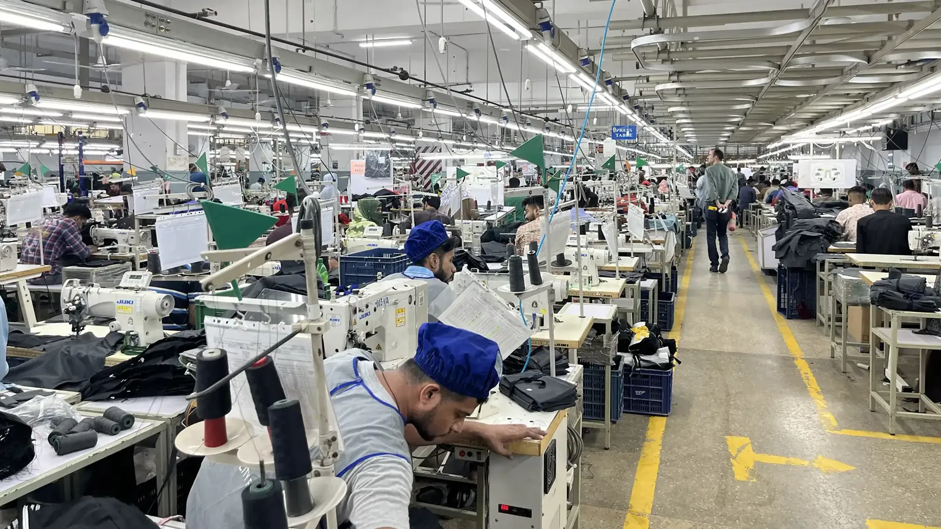 workers at sewing machines during factory inspection